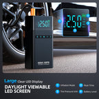Car tire pressure monitor with large clear LED display and daylight viewable screen, shown with a car tire in the background.