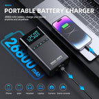 Portable battery charger with smartphone and laptop on a dark background