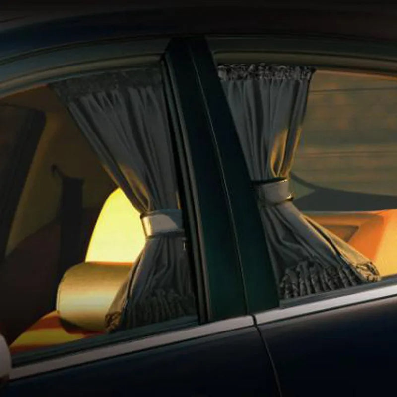Car interior with curtains drawn over the windows, reflecting a warm glow.