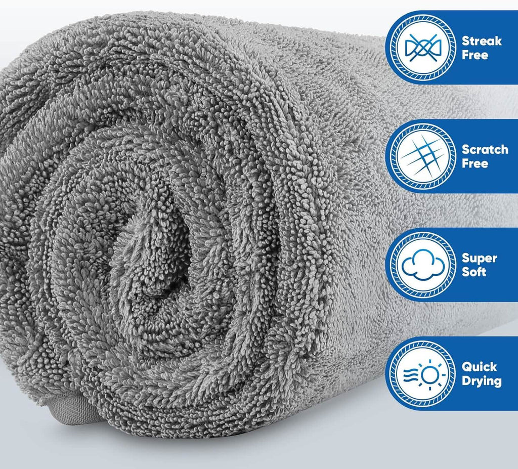 Rolled-up gray towel with cleaning feature icons on a white background