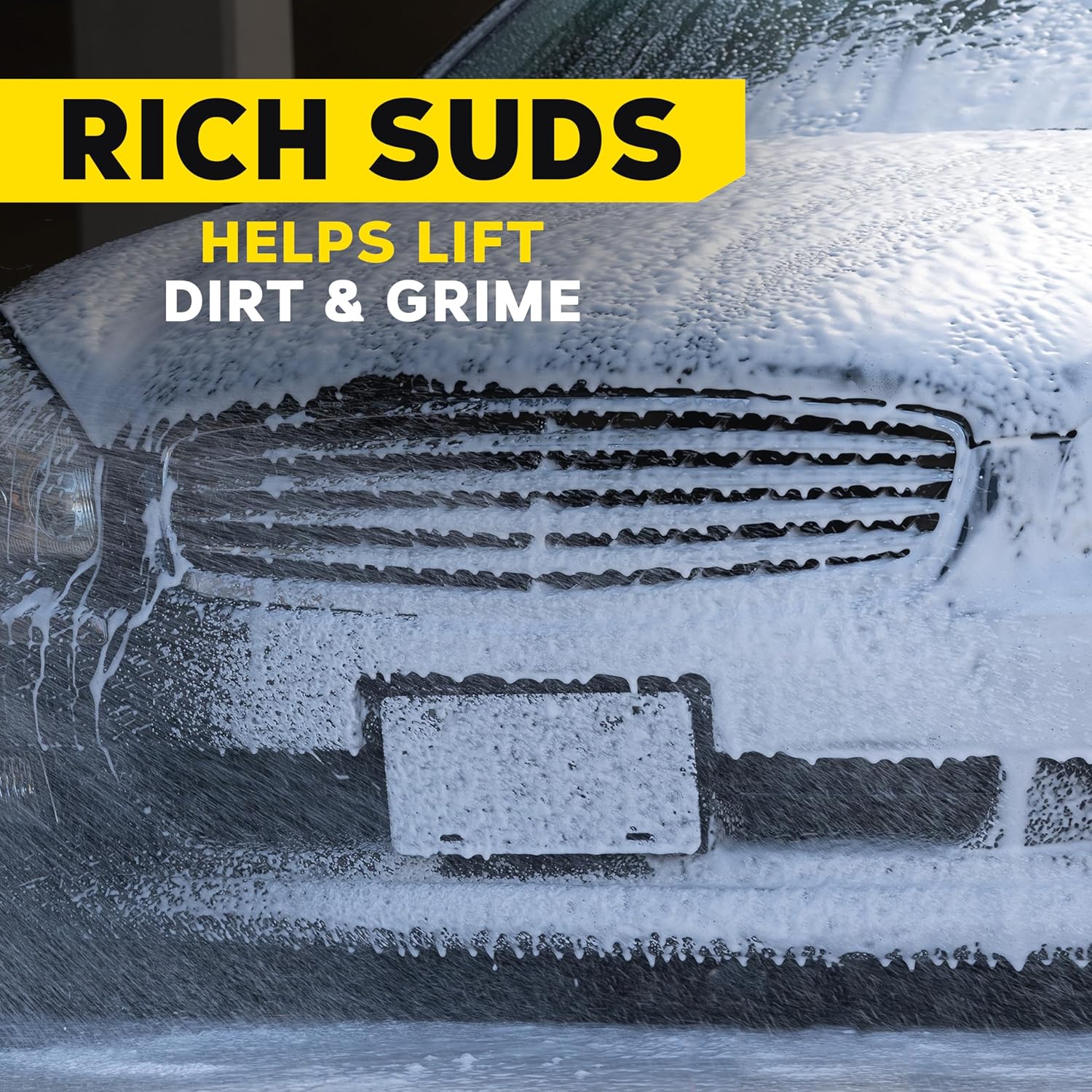 Car with soapy suds on a black background with text 'Rich Suds Helps Lift Dirt & Grime'.