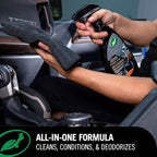 Person cleaning car interior with a spray bottle and towel, with a focus on an all-in-one cleaning formula.