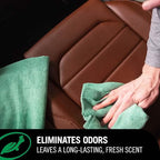 Person cleaning a brown car seat with a green towel, emphasizing odor elimination and fresh scent.