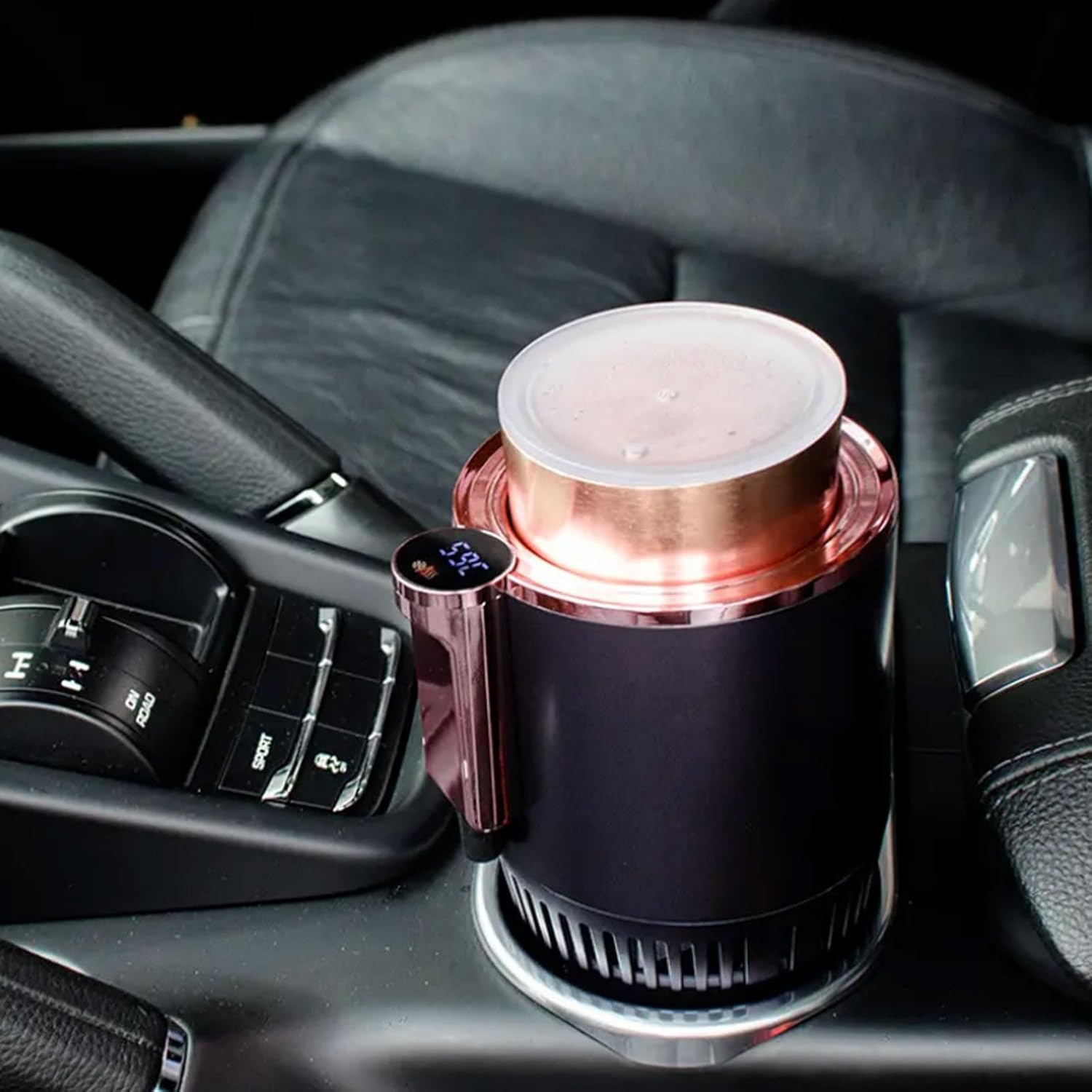 Rose gold and black car cup holder with digital display on a car dashboard.